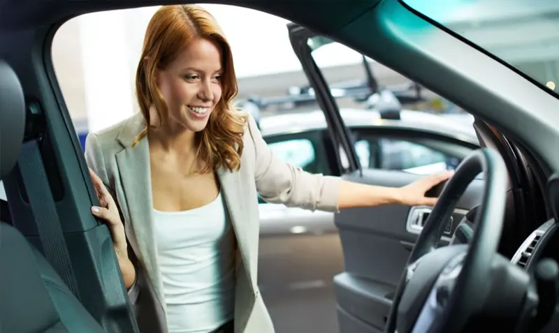 woman looking at a new lease car