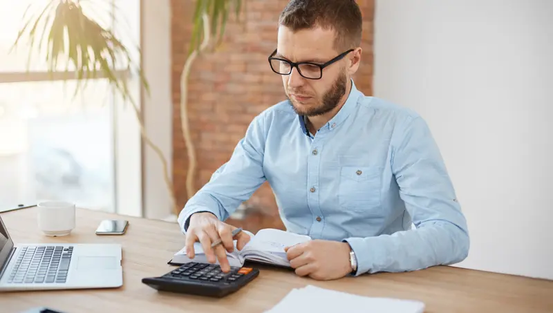 Man calculating business car tax