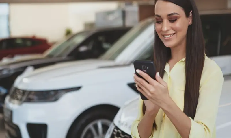 woman searching car lease deals on phone